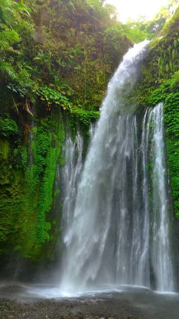 Aerial view of Tiu Kelep Waterfall in the jungle Indonesia.