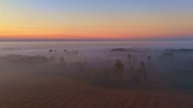 Aerial view of misty landscape at sunrise in Latvia. Aerial view of misty landscape at sunrise in Latvia.
