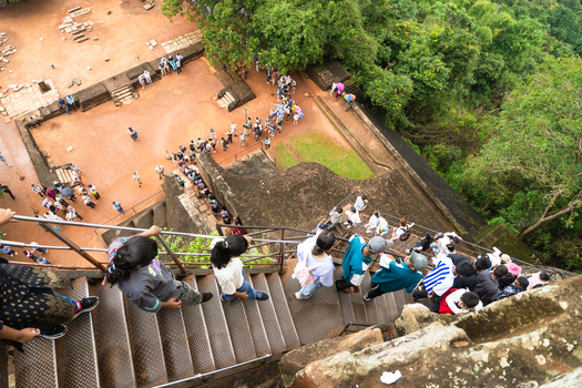 Sri Lanka 21 February 2026 View of tourists climbing the metal stairs and queuing at the ancient Sigiriya rock fortress surrounded by lush green forest.