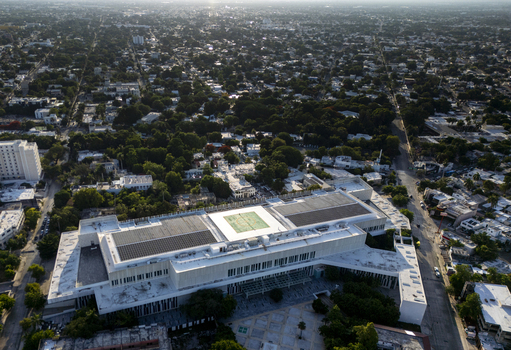 Aerial view of Centro Internacional de Congresos de Yucatan with its modern architecture solar panels on the roof and surrounding urban greenery in Merida Yucatan Mexico. Aerial view of Centro Internacional de Congresos de Yucatan with its modern architecture solar panels on the roof and surrounding urban greenery in Merida Yucatan Mexico.