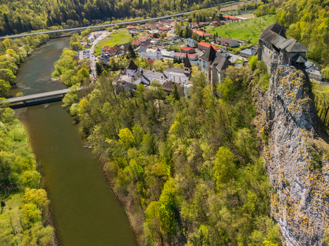 Aerial view of Orava Castle perched on a steep rock cliff overlooking the Orava River and lush green forests in Dolny Kubin Zilinsky kraj Slovakia. Aerial view of Orava Castle perched on a steep rock cliff overlooking the Orava River and lush green forests in Dolny Kubin Zilinsky kraj Slovakia.