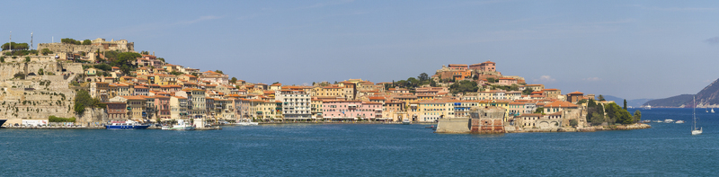 View of the sun kisses the terracotta rooftops of Portoferraio as boats bob gently on the turquoise waters painting a vivid tableau of coastal charm Portoferraio Elba Tuscany Italy. View of the sun kisses the terracotta rooftops of Portoferraio as boats bob gently on the turquoise waters painting a vivid tableau of coastal charm Portoferraio Elba Tuscany Italy.