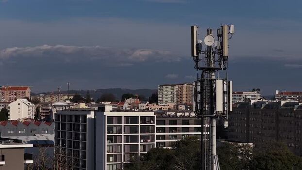 Aerial view of cell tower and city buildings Portugal.