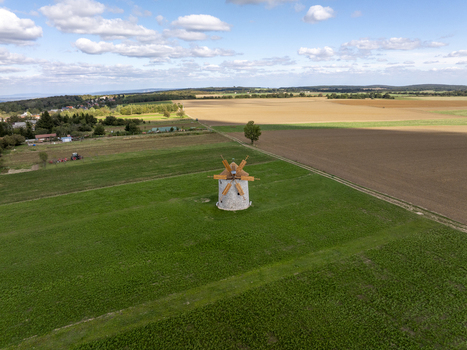 Aerial view of the historic Regi Szelmalom windmill surrounded by green fields and agricultural land in Tes Hungary. Aerial view of the historic Regi Szelmalom windmill surrounded by green fields and agricultural land in Tes Hungary.