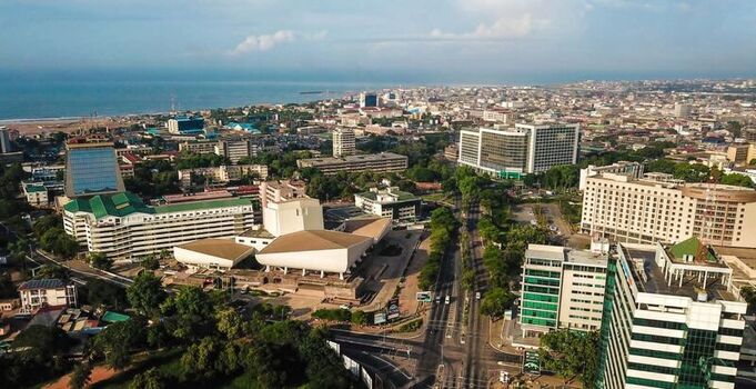Aerial view of the National Theatre of Ghana surrounded by modern office buildings urban streets and the coastline in Accra Ghana. Aerial view of the National Theatre of Ghana surrounded by modern office buildings urban streets and the coastline in Accra Ghana.