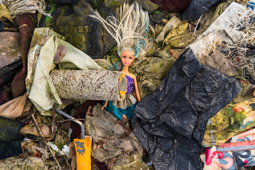 View of a discarded doll lying amidst various pieces of trash plastic bags and debris in Varna Bulgaria. View of a discarded doll lying amidst various pieces of trash plastic bags and debris in Varna Bulgaria.