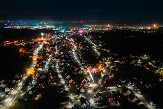 Aerial view of fireworks exploding over the illuminated rooftops and streets of the town at night Forchheim Bavaria Germany. Aerial view of fireworks exploding over the illuminated rooftops and streets of the town at night Forchheim Bavaria Germany.