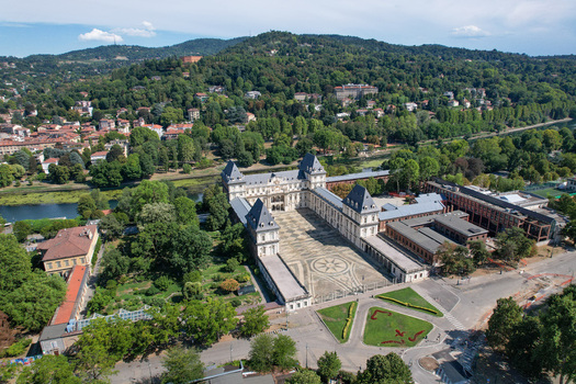 Aerial view of Castello del Valentino with its grand courtyard surrounded by lush greenery and the Po river under a clear sky Torino Piemonte Italy. Aerial view of Castello del Valentino with its grand courtyard surrounded by lush greenery and the Po river under a clear sky Torino Piemonte Italy.