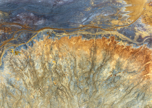 Aerial view of the abstract textures and colorful mineral deposits at the historic mining site Minas de Riotinto Andalusia Spain.