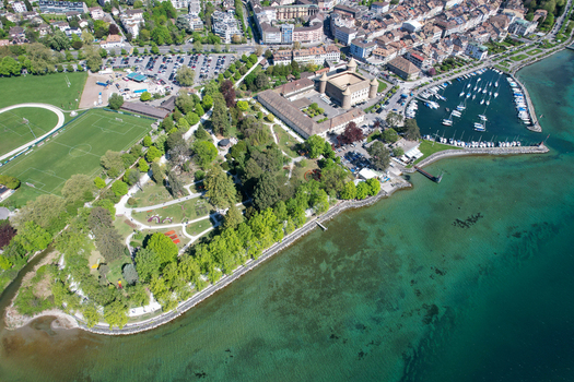 Aerial view of Chateau de Morges the marina with sailboats and the lush Parc de l Independance along the shores of Lake Geneva in Morges Vaud Switzerland. Aerial view of Chateau de Morges the marina with sailboats and the lush Parc de l Independance along the shores of Lake Geneva in Morges Vaud Switzerland.