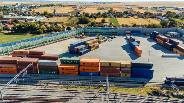 Indjija Serbia 24 August 2026 Aerial view of a container terminal with stacked shipping containers railway tracks in the foreground and agricultural fields in the background.