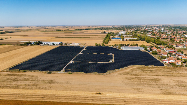 Aerial view of a large solar farm with rows of photovoltaic panels situated in the rural landscape near Temerin Vojvodina Serbia. Aerial view of a large solar farm with rows of photovoltaic panels situated in the rural landscape near Temerin Vojvodina Serbia.