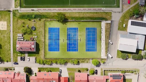 Aerial view of blue tennis courts and urban buildings Czechia. Aerial view of blue tennis courts and urban buildings Czechia.