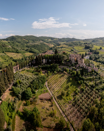 Aerial view of the historic village of Montefioralle surrounded by lush vineyards olive groves and rolling hills in the Tuscan countryside Montefioralle Tuscany Italy. Aerial view of the historic village of Montefioralle surrounded by lush vineyards olive groves and rolling hills in the Tuscan countryside Montefioralle Tuscany Italy.