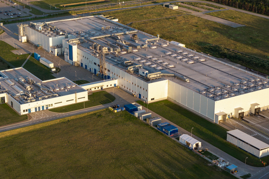 Aerial view of an advanced food production facility with industrial HVAC units and surrounding green fields in mazowieckie Poland. Aerial view of an advanced food production facility with industrial HVAC units and surrounding green fields in mazowieckie Poland.