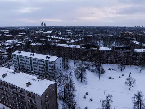 Aerial view of the Agenskalna priedes neighborhood with snow covered apartment buildings bare trees and a park area in winter Riga Latvia. Aerial view of the Agenskalna priedes neighborhood with snow covered apartment buildings bare trees and a park area in winter Riga Latvia.