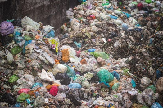 View of large piles of colorful plastic bags and organic waste at the Forsu Iren treatment plant in Reggio nell Emilia Emilia Romagna Italy. View of large piles of colorful plastic bags and organic waste at the Forsu Iren treatment plant in Reggio nell Emilia Emilia Romagna Italy.