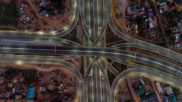 Aerial view of the illuminated Pokuase Interchange at night featuring complex multi level highway ramps and surrounding urban development in Ga North Municipal Greater Accra Region Ghana. Aerial view of the illuminated Pokuase Interchange at night featuring complex multi level highway ramps and surrounding urban development in Ga North Municipal Greater Accra Region Ghana.