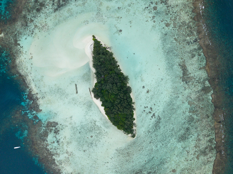 Aerial view of a vibrant island surrounded by turquoise waters and coral reefs a tropical haven Karimunjawa Central Java Indonesia.