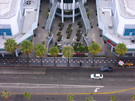 Los Angeles California United States 25 September 2026 Aerial view of Hollywood Walk of Fame with iconic stars embedded in the sidewalk lined with palm trees and modern buildings.