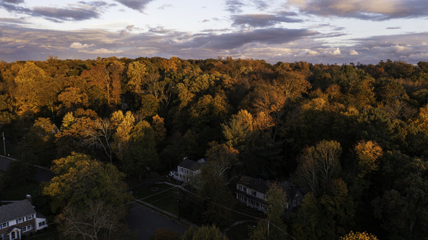 Aerial view of residential houses nestled among vibrant autumn trees in Summit New Jersey United States. Aerial view of residential houses nestled among vibrant autumn trees in Summit New Jersey United States.