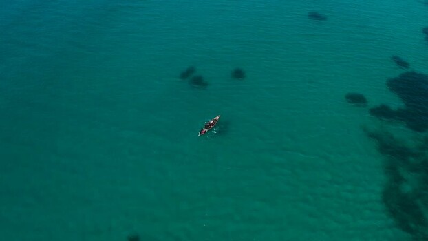 Aerial view of boat in blue water Mozambique.