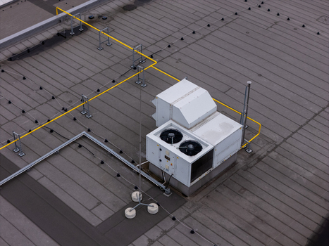 Aerial view of HVAC units and yellow pipes on a flat rooftop in Gdansk Poland. Aerial view of HVAC units and yellow pipes on a flat rooftop in Gdansk Poland.