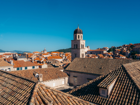 View of the historic terracotta rooftops and the bell tower of the Franciscan Monastery in Dubrovnik Old Town under a clear blue sky Dubrovnik Dubrovnik Neretva County Croatia. View of the historic terracotta rooftops and the bell tower of the Franciscan Monastery in Dubrovnik Old Town under a clear blue sky Dubrovnik Dubrovnik Neretva County Croatia.