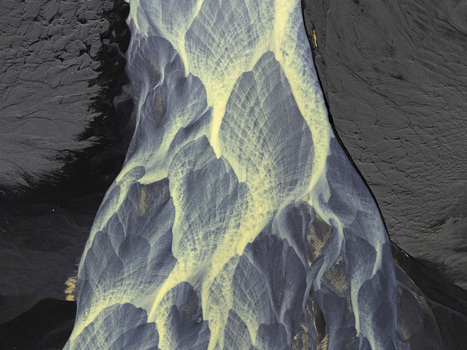 Aerial view of intricate braided glacial river patterns flowing through dark volcanic sand with abstract textures Hallgeirseyjarvegur Rangarthing eystra Iceland. Aerial view of intricate braided glacial river patterns flowing through dark volcanic sand with abstract textures Hallgeirseyjarvegur Rangarthing eystra Iceland.
