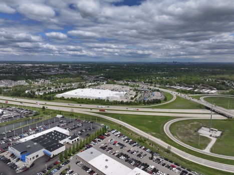 Aerial view of large car dealership parking lots and a highway interchange under a cloudy sky in Columbus Ohio United States. Aerial view of large car dealership parking lots and a highway interchange under a cloudy sky in Columbus Ohio United States.