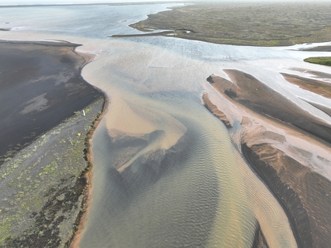 Aerial view of the river delta with dark volcanic sand banks and flowing water in Selfoss Sveitarfelagid Arborg Iceland. Aerial view of the river delta with dark volcanic sand banks and flowing water in Selfoss Sveitarfelagid Arborg Iceland.