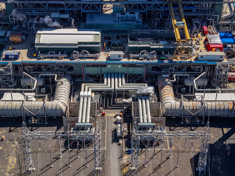 Aerial view of Millmerran Power Station featuring complex industrial piping steel structures and power generation equipment at the facility in Domville Queensland Australia. Aerial view of Millmerran Power Station featuring complex industrial piping steel structures and power generation equipment at the facility in Domville Queensland Australia.