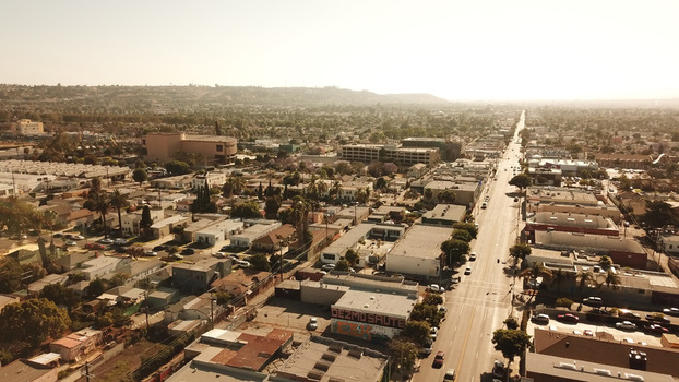 Aerial view of the urban landscape with residential and commercial buildings along a busy street in Los Angeles California United States. Aerial view of the urban landscape with residential and commercial buildings along a busy street in Los Angeles California United States.