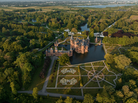 Aerial view of De Haar Castle with its majestic towers and formal gardens surrounded by a moat and lush green parkland in Utrecht Utrecht Netherlands. Aerial view of De Haar Castle with its majestic towers and formal gardens surrounded by a moat and lush green parkland in Utrecht Utrecht Netherlands.