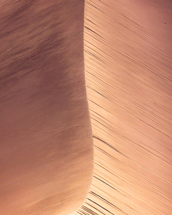 View of the Valley of the Moon featuring a sharp sand dune ridge with wind blown ripples under warm sunset light in San Pedro de Atacama Antofagasta Chile. View of the Valley of the Moon featuring a sharp sand dune ridge with wind blown ripples under warm sunset light in San Pedro de Atacama Antofagasta Chile.