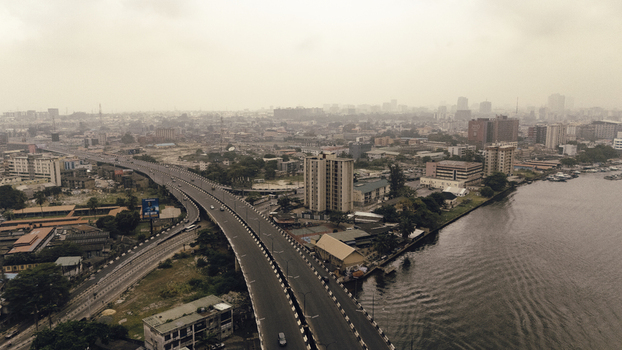 Aerial view of Lagos Island featuring the bridge over the lagoon with urban buildings and infrastructure in Lagos Lagos Nigeria. Aerial view of Lagos Island featuring the bridge over the lagoon with urban buildings and infrastructure in Lagos Lagos Nigeria.