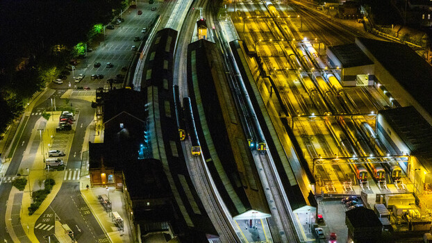 Aerial view of Salisbury railway station at night with illuminated platforms parked trains and surrounding parking lots in Salisbury England United Kingdom. Aerial view of Salisbury railway station at night with illuminated platforms parked trains and surrounding parking lots in Salisbury England United Kingdom.