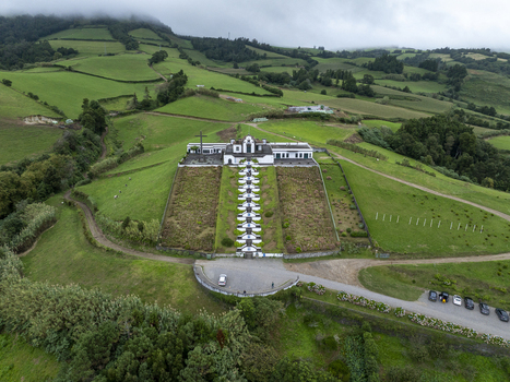 Aerial view of the Chapel of Nossa Senhora da Paz with its iconic long staircase surrounded by lush green hills and fields in Vila Franca Do Campo Acores Portugal. Aerial view of the Chapel of Nossa Senhora da Paz with its iconic long staircase surrounded by lush green hills and fields in Vila Franca Do Campo Acores Portugal.
