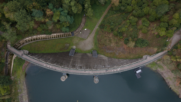Aerial view of Sengbachtalsperre dam with its curved concrete wall and surrounding dense forest in Solingen Nordrhein Westfalen Germany. Aerial view of Sengbachtalsperre dam with its curved concrete wall and surrounding dense forest in Solingen Nordrhein Westfalen Germany.