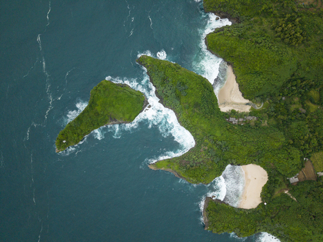 Aerial view of Sedahan Beach lush green deep blue white waves golden sand small island Gunungkidul Regency Special Region of Yogyakarta Indonesia. Aerial view of Sedahan Beach lush green deep blue white waves golden sand small island Gunungkidul Regency Special Region of Yogyakarta Indonesia.