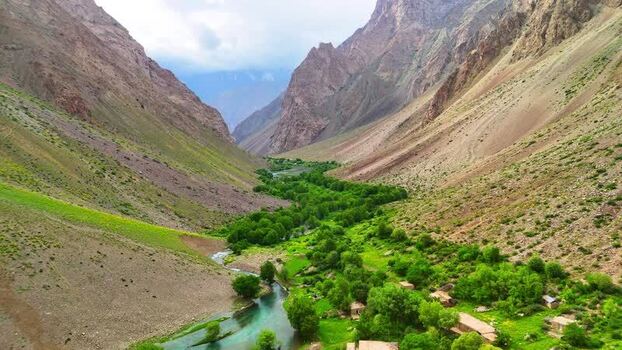 Aerial view of Qullai Vudor and the lush river valley Tajikistan. Aerial view of Qullai Vudor and the lush river valley Tajikistan.