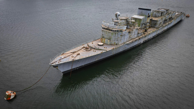 Aerial view of a weathered warship moored in the tranquil waters its stark silhouette contrasting against the serene backdrop Landévennec France. Aerial view of a weathered warship moored in the tranquil waters its stark silhouette contrasting against the serene backdrop Landévennec France.