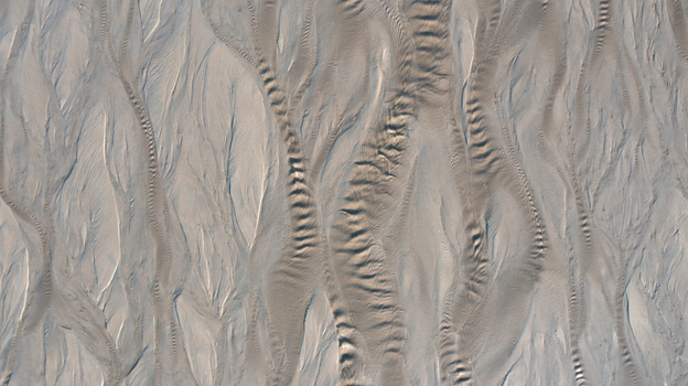 Aerial view of abstract patterns and ripples in the sand at low tide on the beach in Mothecombe Devon United Kingdom. Aerial view of abstract patterns and ripples in the sand at low tide on the beach in Mothecombe Devon United Kingdom.