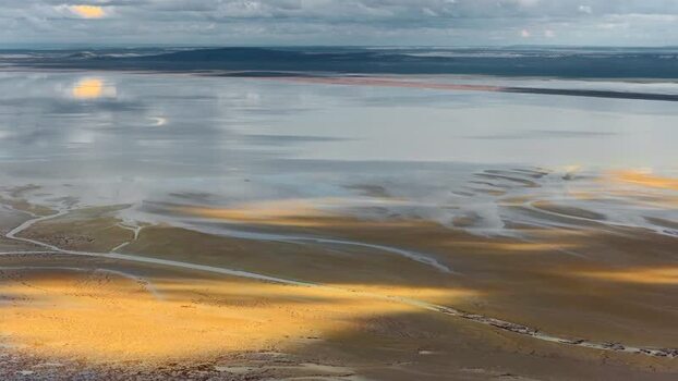 Aerial view of salt flats and reflective lake in Aktau Kazakhstan.