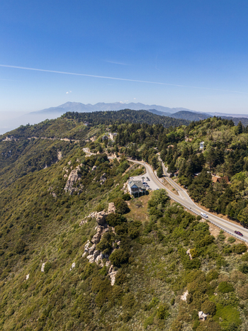 Crestline United States 07 April 2026 Aerial view of Hortencia s at the Cliffhanger restaurant perched on a steep ridge overlooking winding mountain roads and lush green forests. Crestline United States 07 April 2026 Aerial view of Hortencia s at the Cliffhanger restaurant perched on a steep ridge overlooking winding mountain roads and lush green forests.
