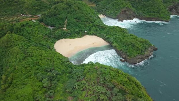 Aerial view of Sedahan Beach and green cliffs in Indonesia.