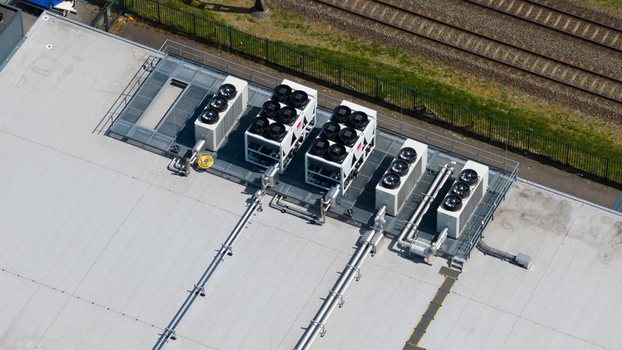 Aerial view of industrial HVAC cooling units and ventilation systems on a flat rooftop near railway tracks in Utrecht Utrecht Netherlands. Aerial view of industrial HVAC cooling units and ventilation systems on a flat rooftop near railway tracks in Utrecht Utrecht Netherlands.