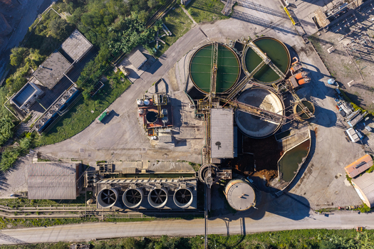 Aerial view of Acciai Speciali Terni S.p.A. industrial facility featuring circular water treatment tanks cooling towers and infrastructure in Terni Umbria Italy.