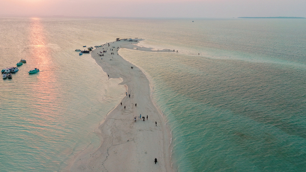 Aerial view of Pulau Gusung Sanggalau surrounded by turquoise waters and coral reefs in Kecamatan Pulau Derawan Kalimantan Timur Indonesia. Aerial view of Pulau Gusung Sanggalau surrounded by turquoise waters and coral reefs in Kecamatan Pulau Derawan Kalimantan Timur Indonesia.