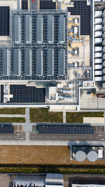 Aerial view of a modern data center campus with solar panels cooling units and industrial infrastructure in Melegnano Lombardy Italy.